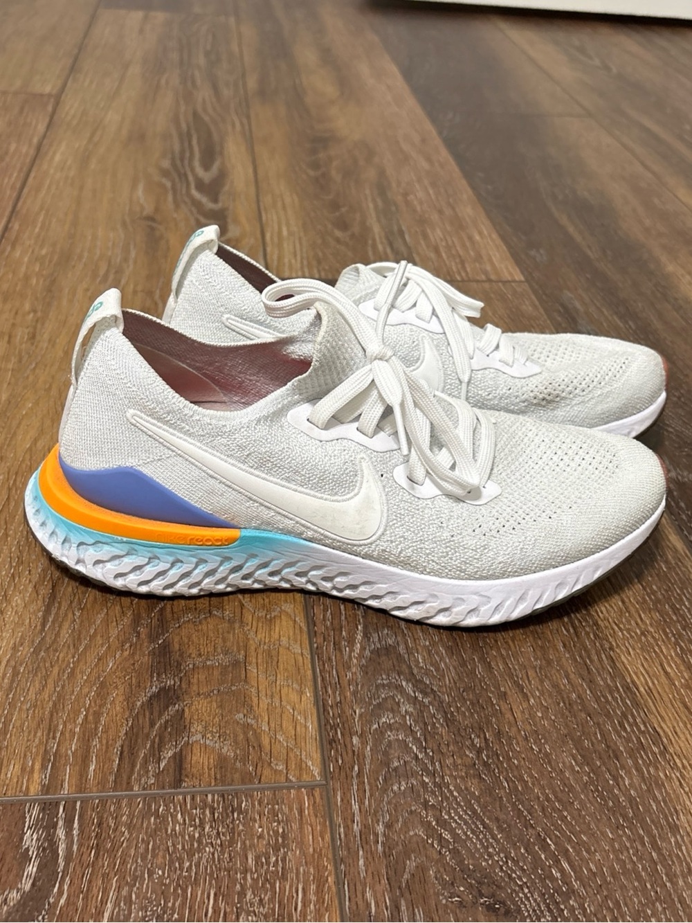 Nike White Running Shoes with Blue and Orange Accents